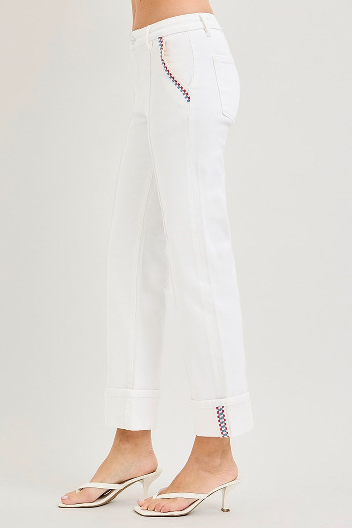 White pants with decorative hem on a white background