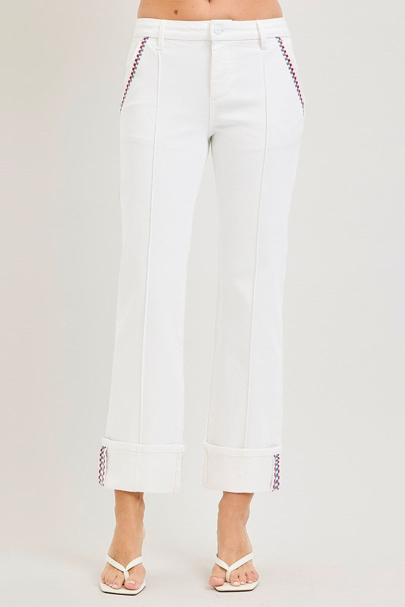 White pants with red stitching on a light gray background