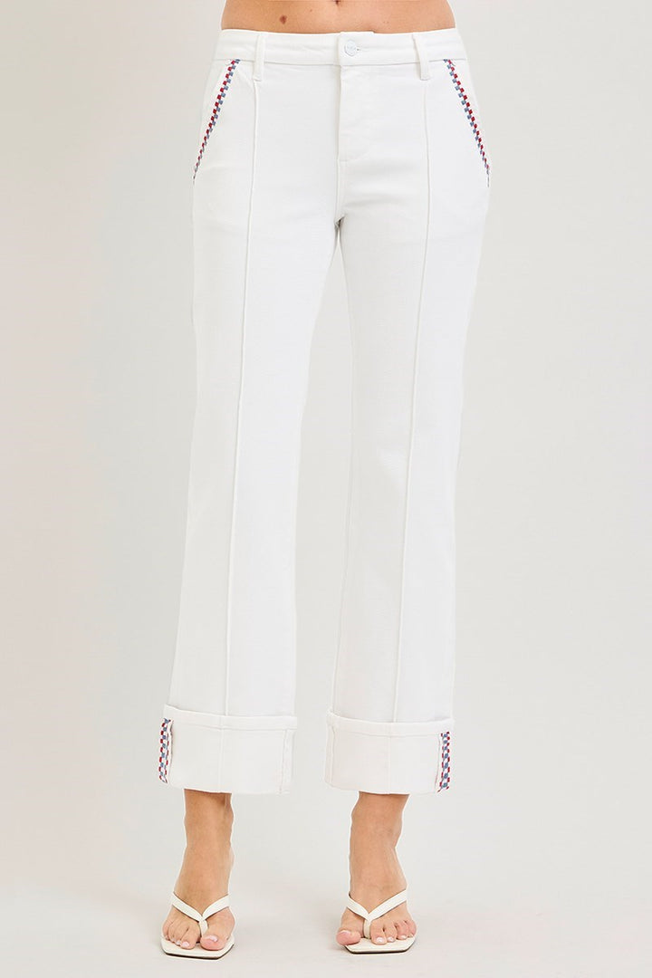 White pants with red stitching on a light gray background