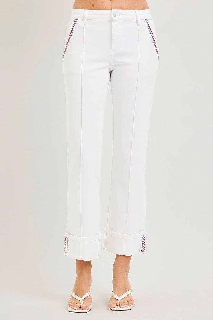 White pants with red stitching on a light gray background