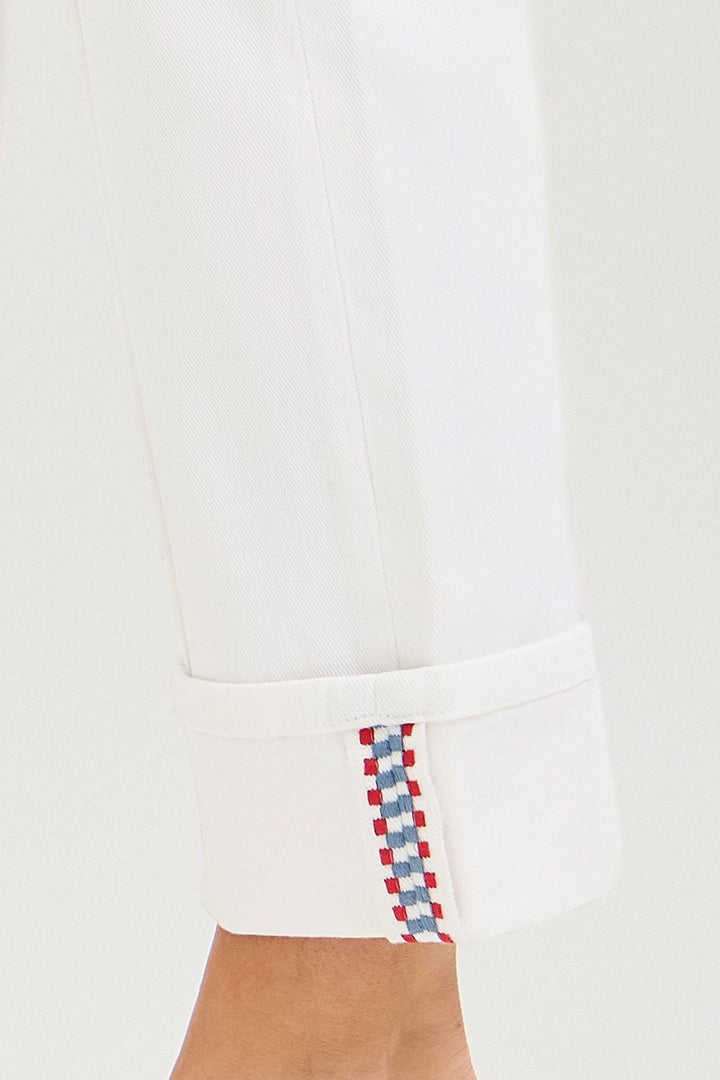 Close-up of a white shirt with red, white, and blue checkered pattern on a plain background