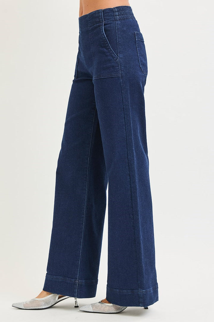 Blue wide-leg jeans worn by a person on a white background