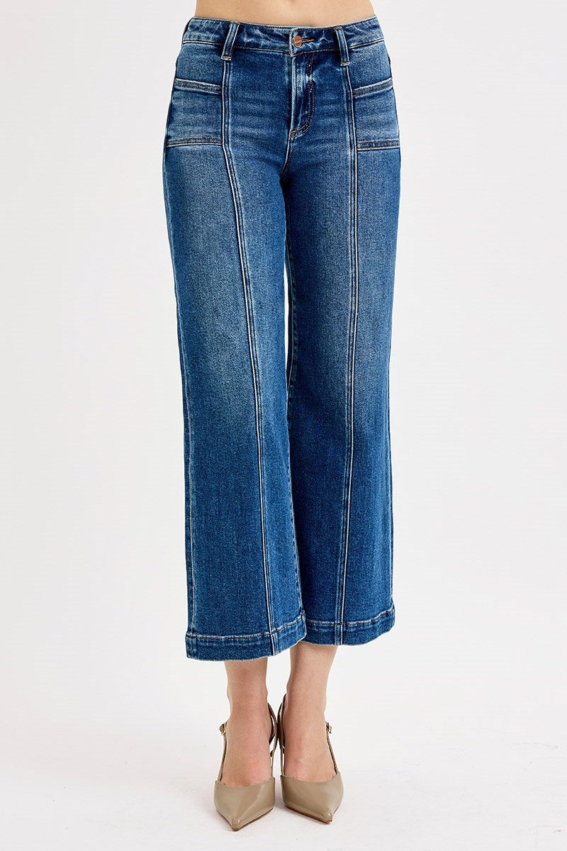 Blue jeans worn by a person on a white background