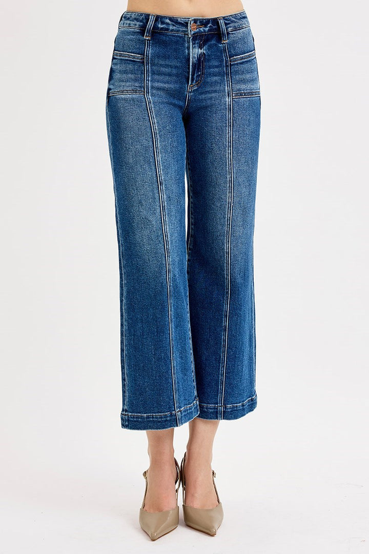 Blue jeans worn by a person on a white background