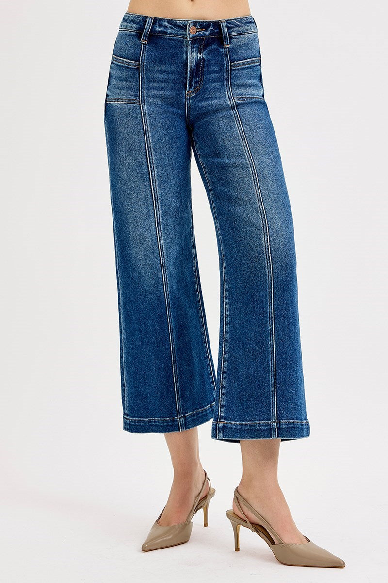 Blue jeans worn by a person on a white background