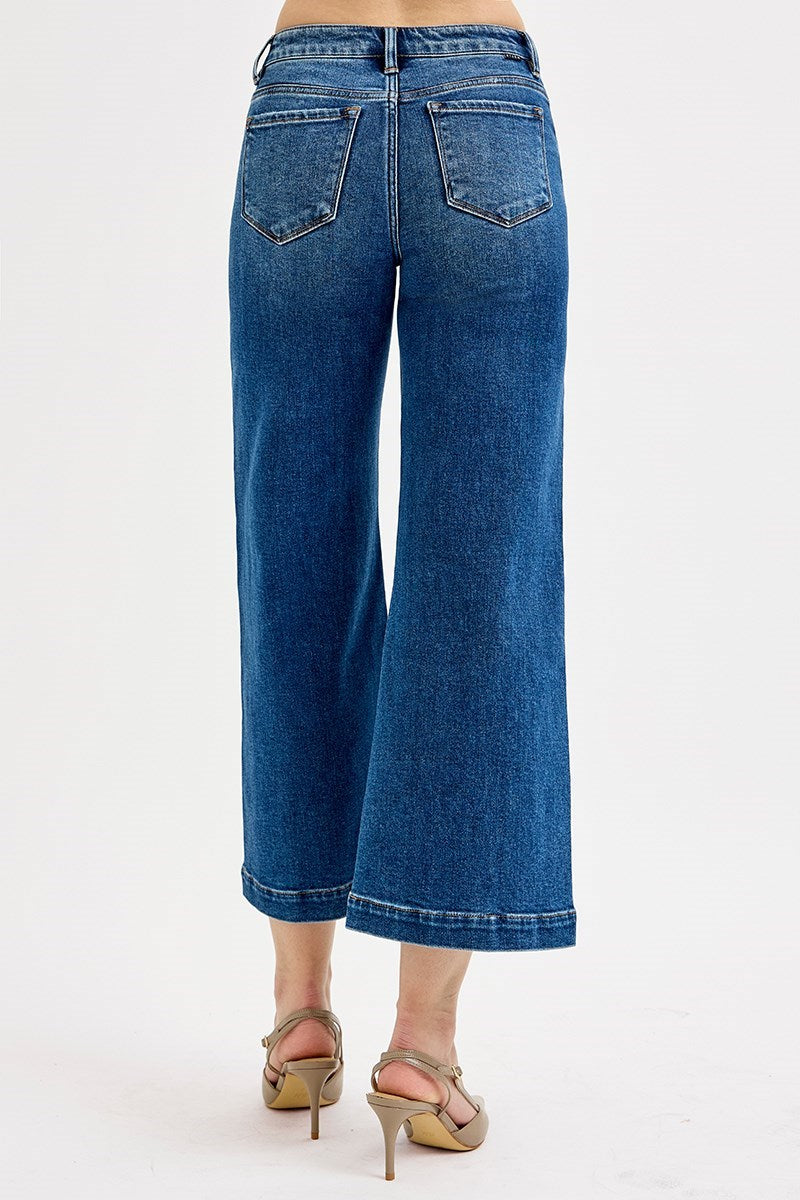 Blue jeans worn by a person on a white background