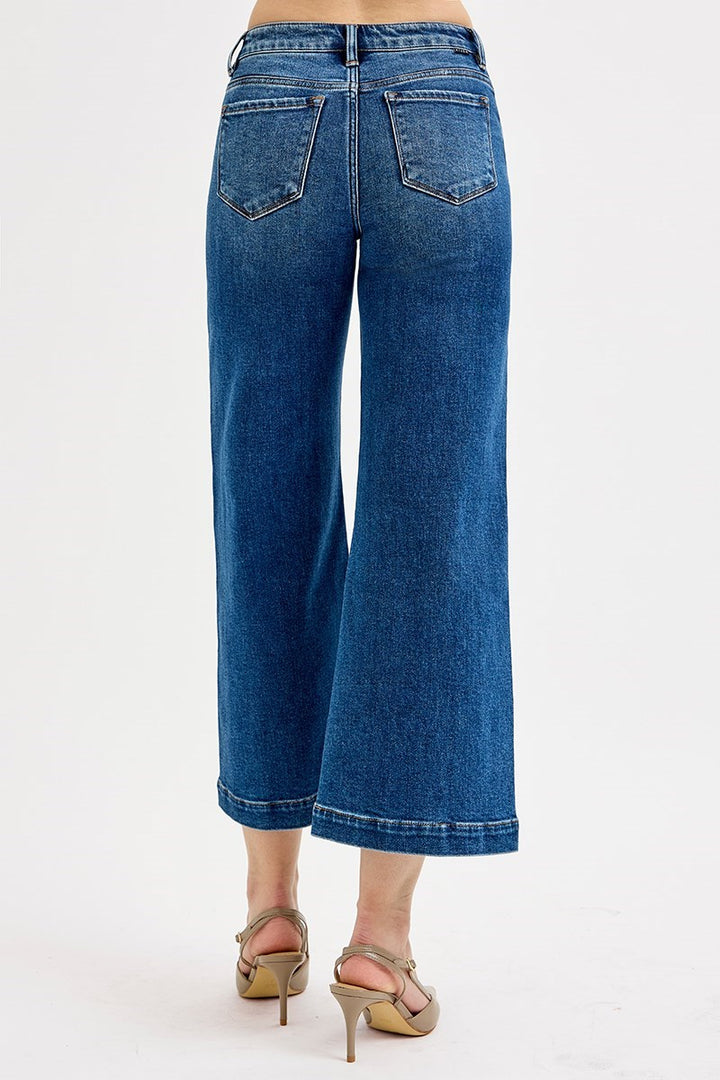 Blue jeans worn by a person on a white background