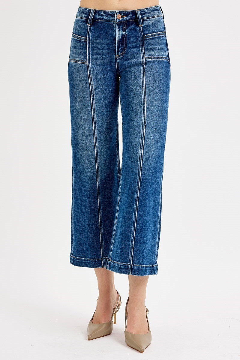 Blue jeans worn by a person on a white background