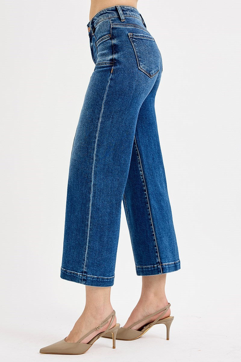Blue jeans worn by a person on a white background