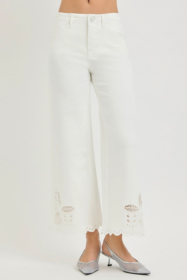 White jeans with lace details on a white background