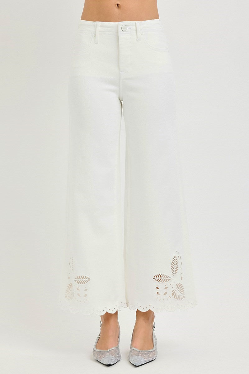 White pants with floral embroidery on a white background