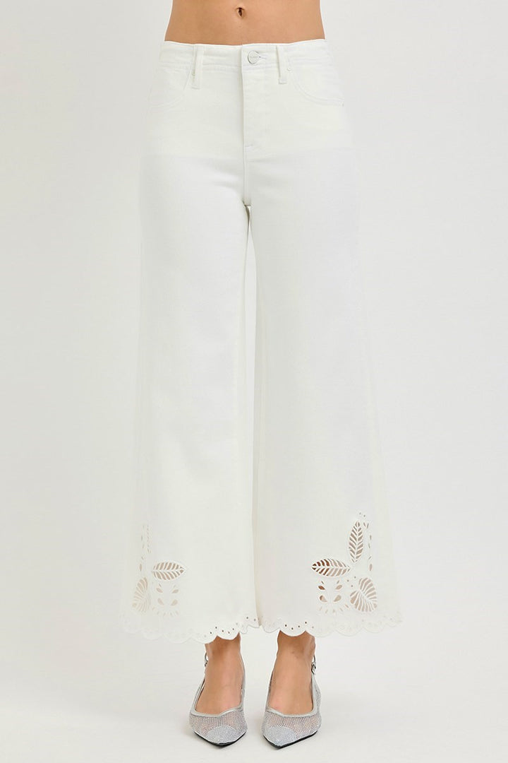 White pants with floral embroidery on a white background