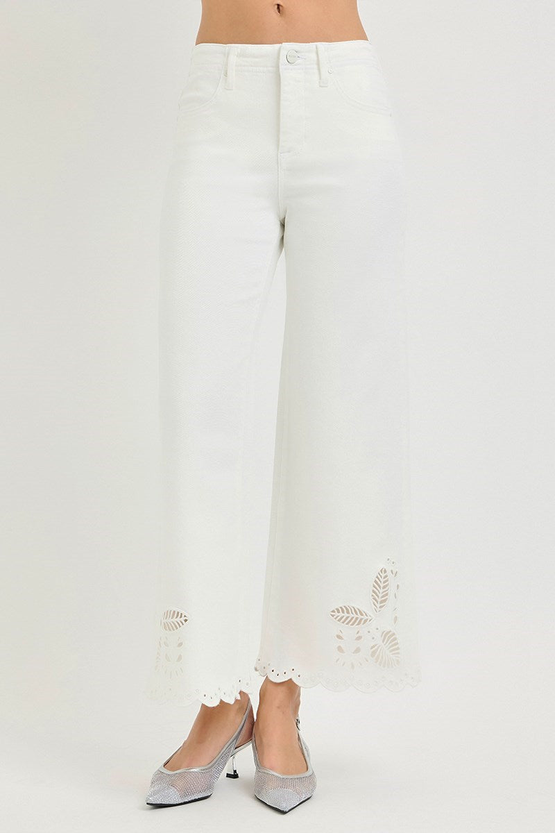 White pants with decorative elements on a white background