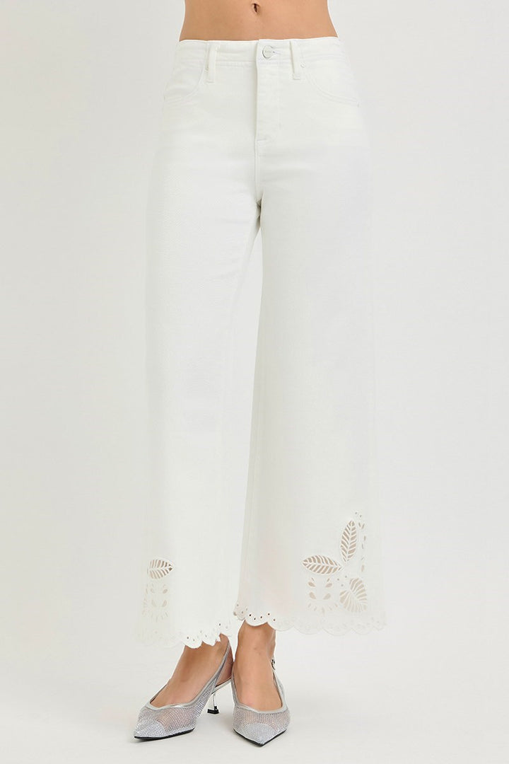 White pants with decorative elements on a white background
