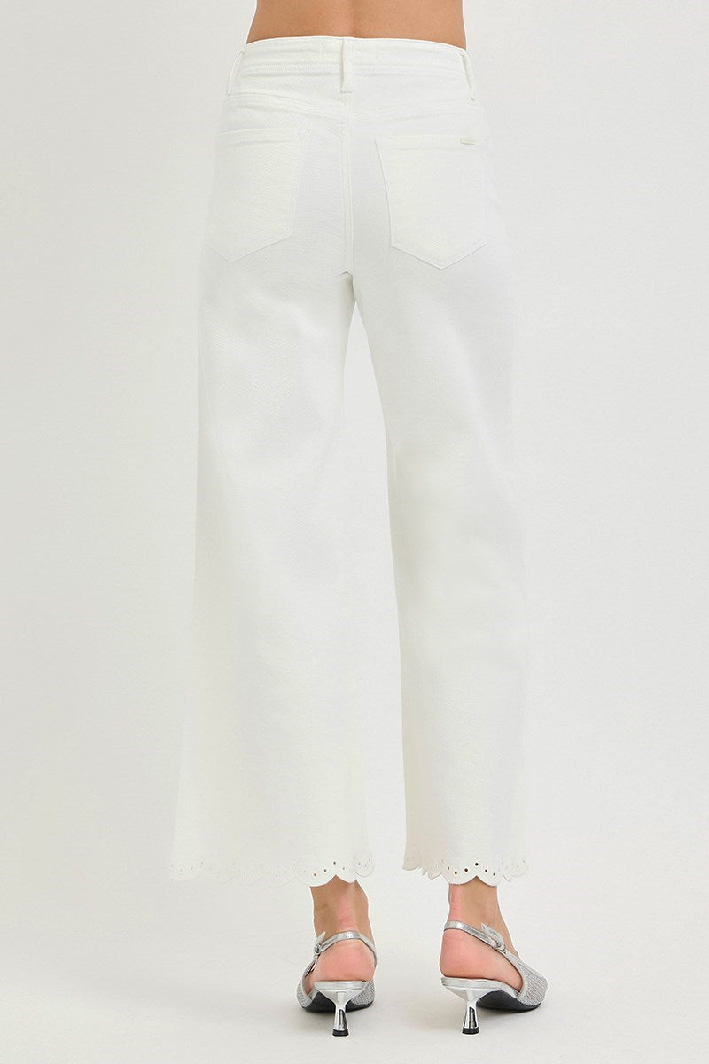 White pants worn by a person on a white background