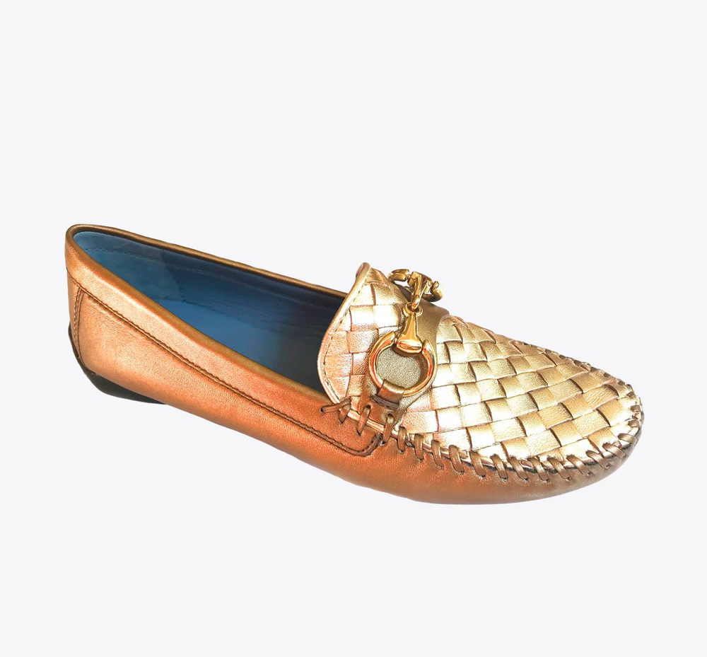 Gold loafer shoe with woven design on a white background