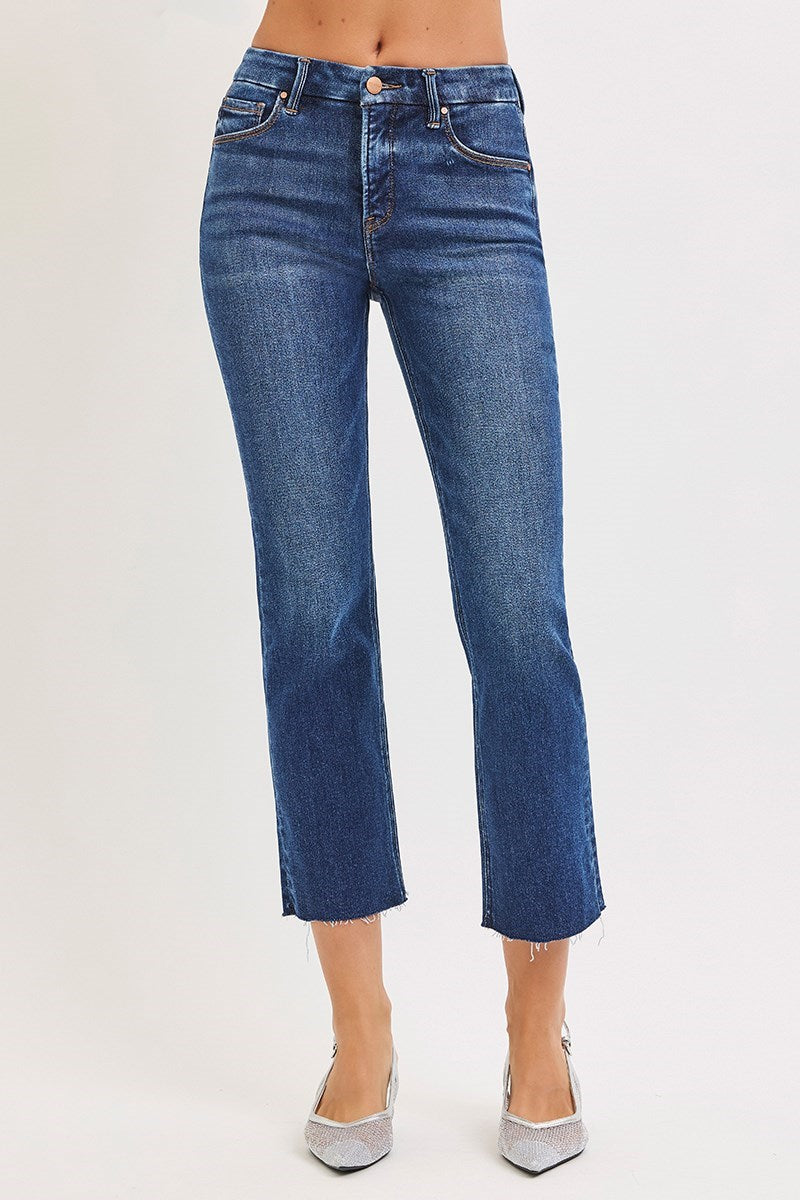 Blue jeans worn by a person on a white background