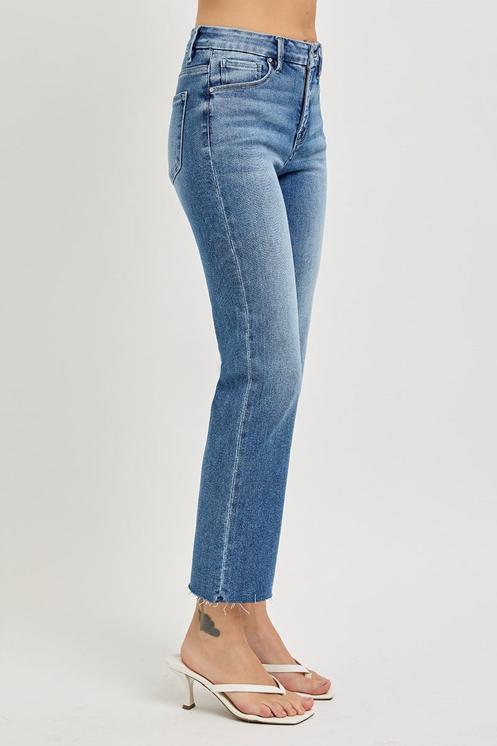 Blue jeans worn by a person on a white background