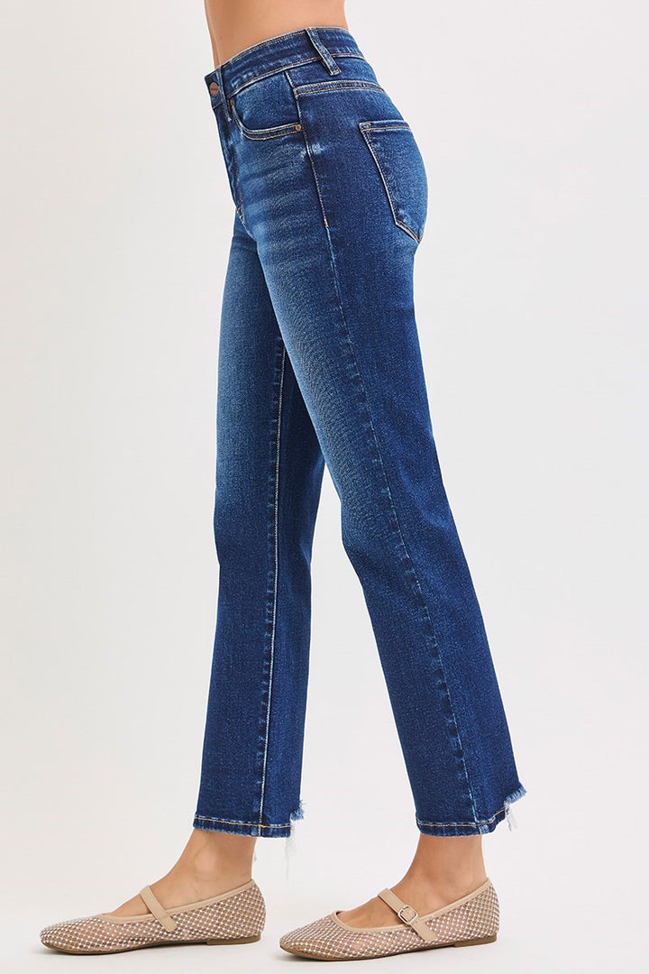 Blue jeans worn by a person on a white background