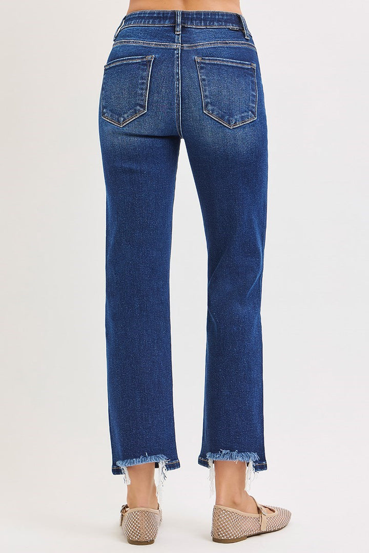 Blue jeans worn by a person on a white background