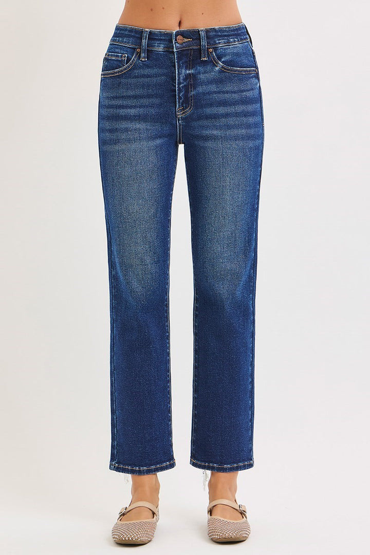 Blue jeans worn by a person on a white background