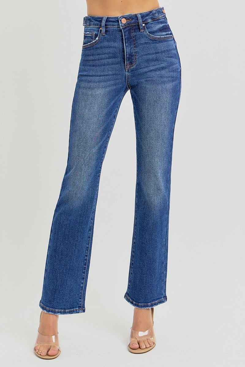 Blue jeans worn by a person on a plain background