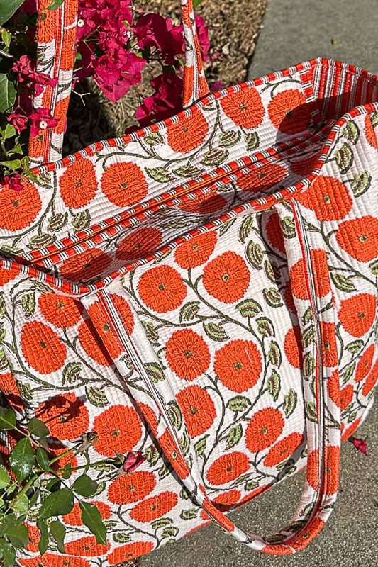 Floral patterned bag with orange flowers on a white background
