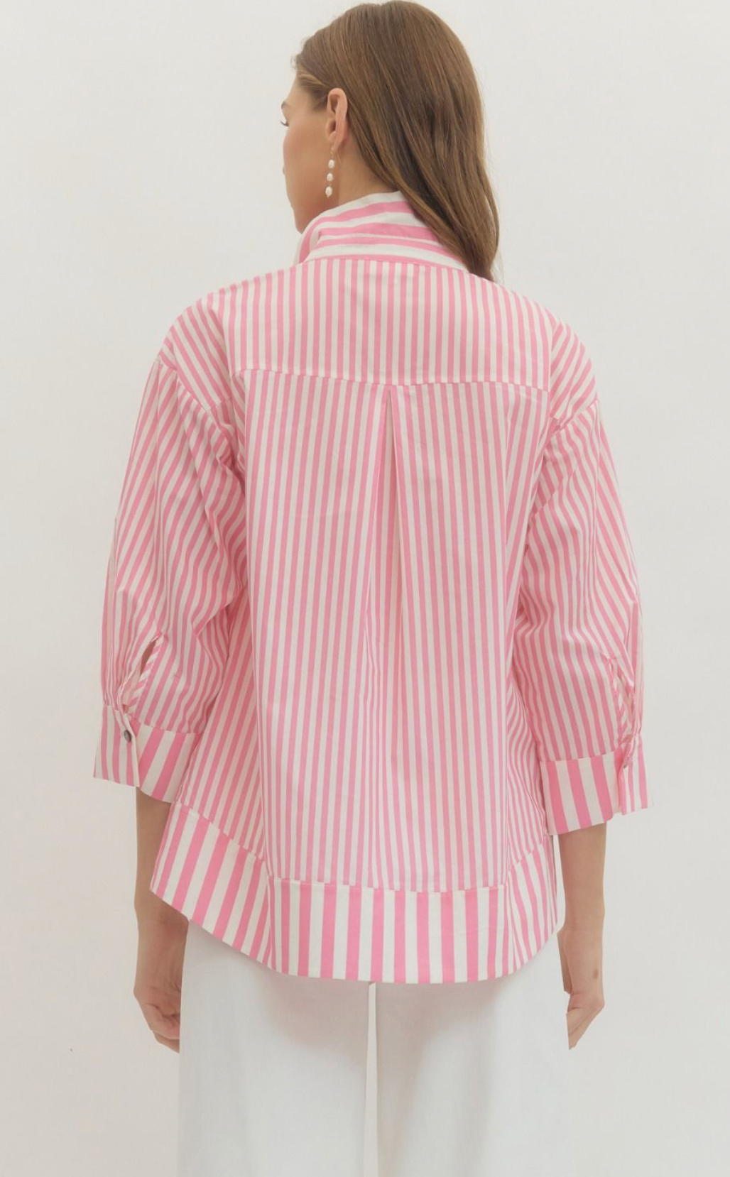 Woman wearing a pink and white striped shirt against a white background