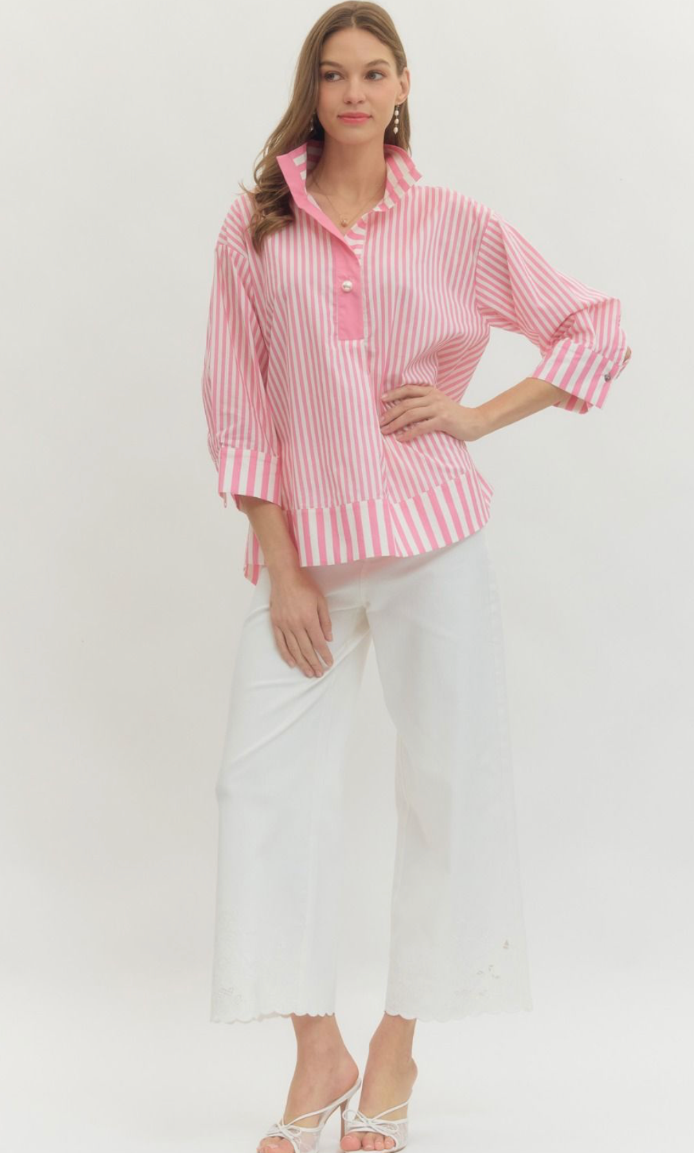 Woman wearing a pink and white striped shirt with a white background