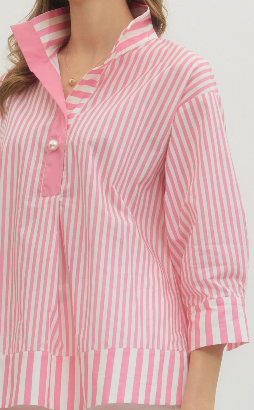 Pink and white striped shirt with a collar on a plain background