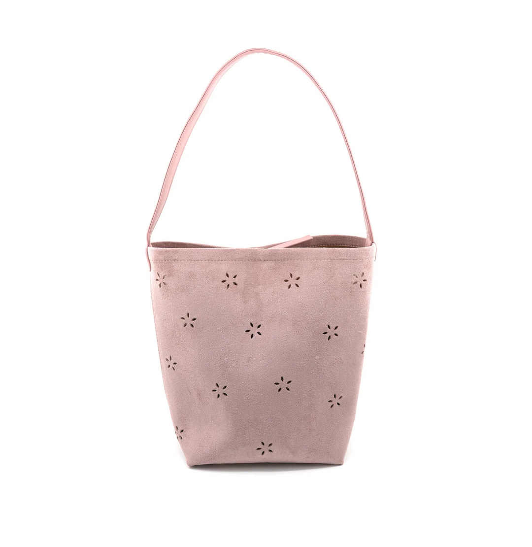 Pink bucket bag with floral cut-out details on a white background
