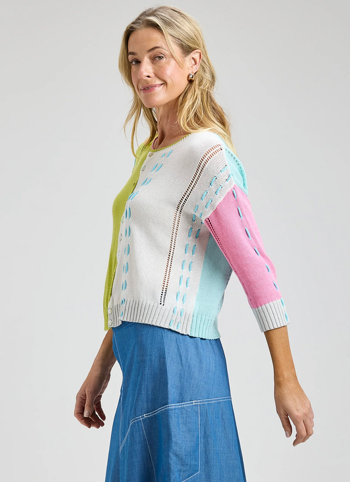Woman wearing a colorful sweater with a white background