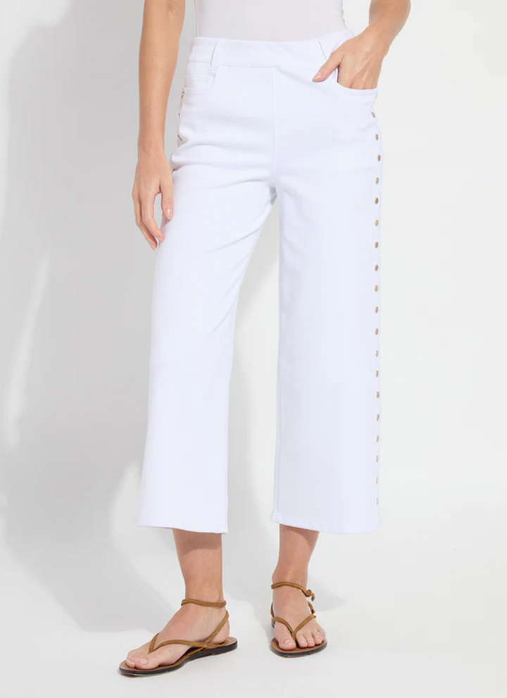 Person wearing white pants on a plain background