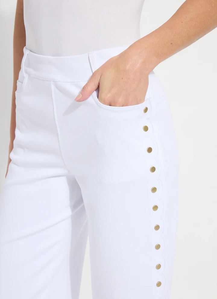 White pants with gold buttons worn by a person on a white background
