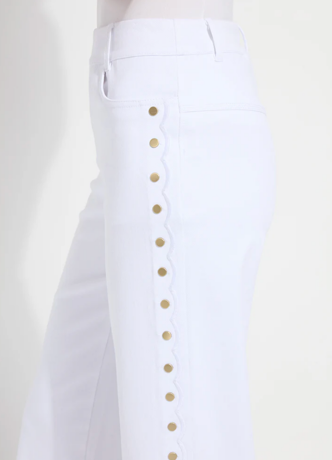 White pants with gold buttons on a white background