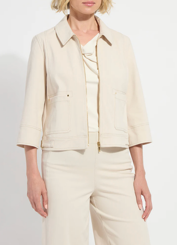 Woman wearing a beige jacket and pants set on a white background