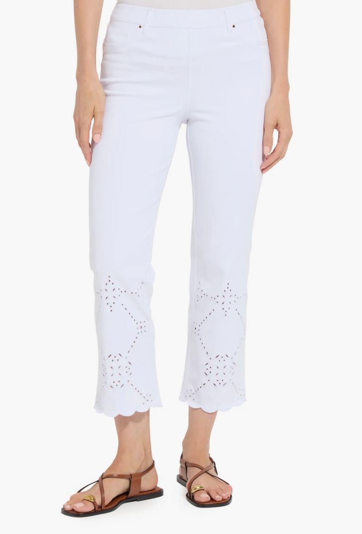 White pants with eyelet details worn by a person on a white background