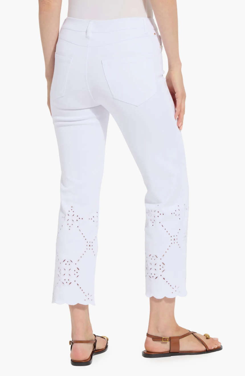 White pants with eyelet details worn by a person on a white background