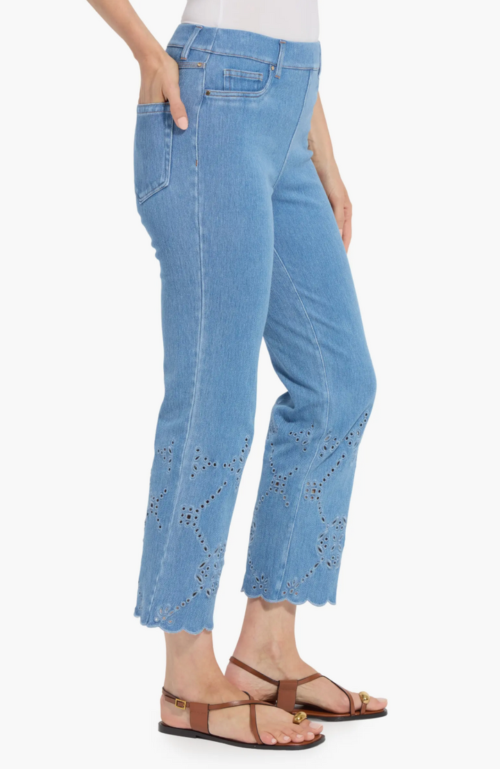 Light blue jeans with decorative cutouts on a white background