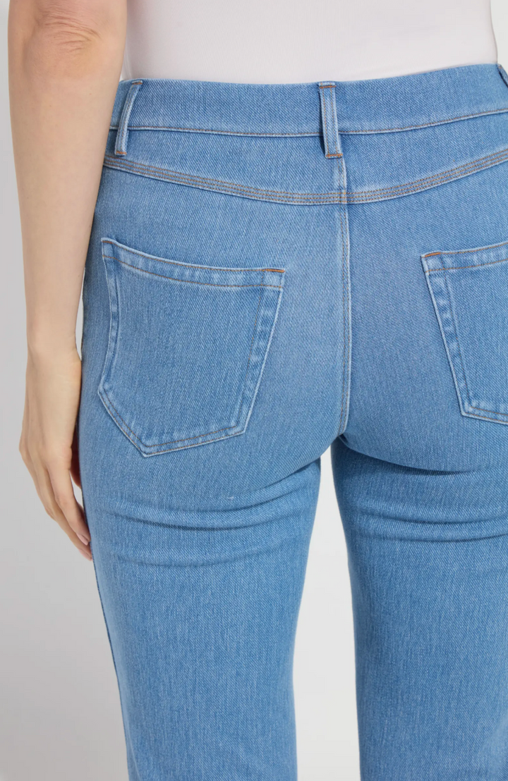 Close-up of blue jeans with a plain background