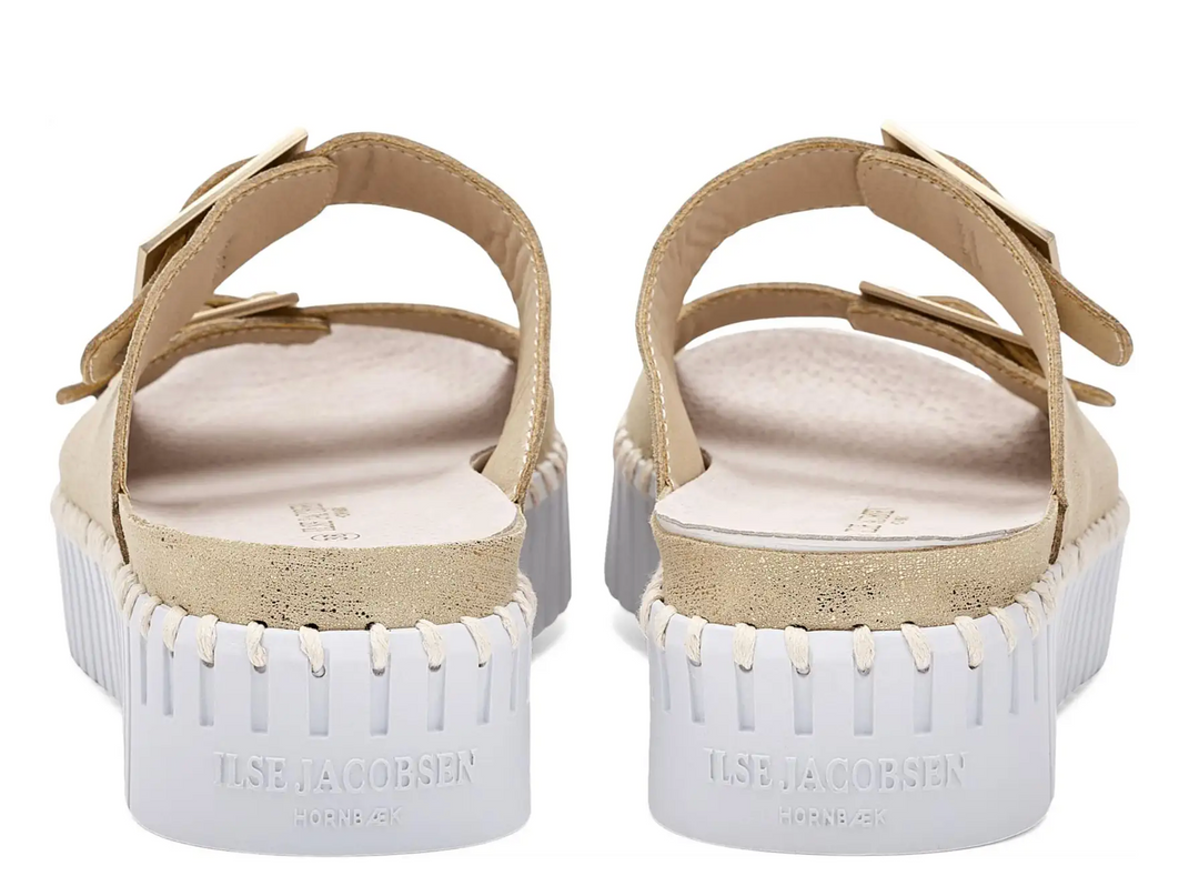 Pair of sandals with white soles and beige straps on a white background
