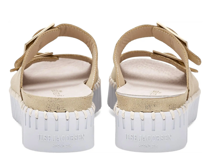 Pair of sandals with white soles and beige straps on a white background