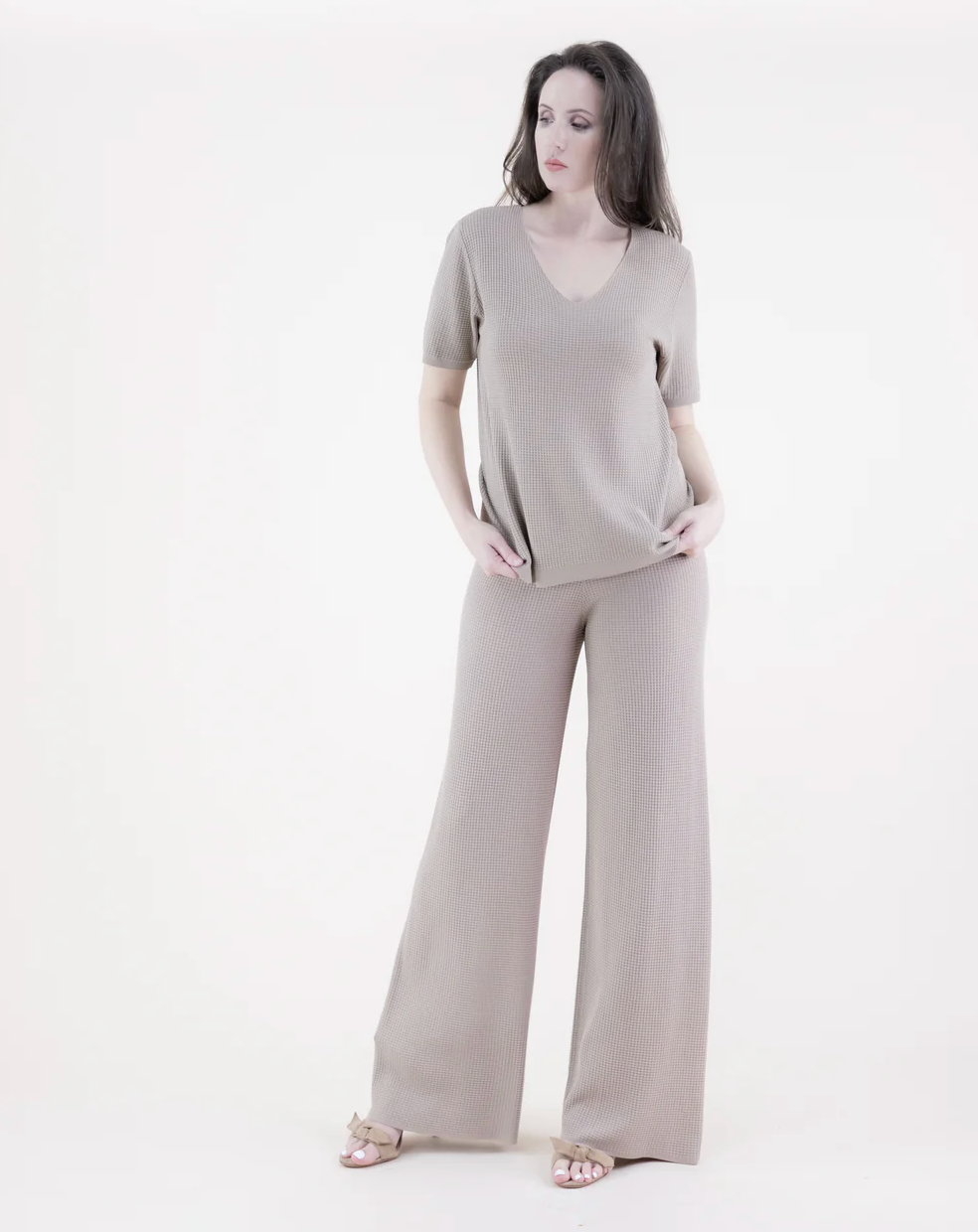 Woman wearing a gray outfit on a white background