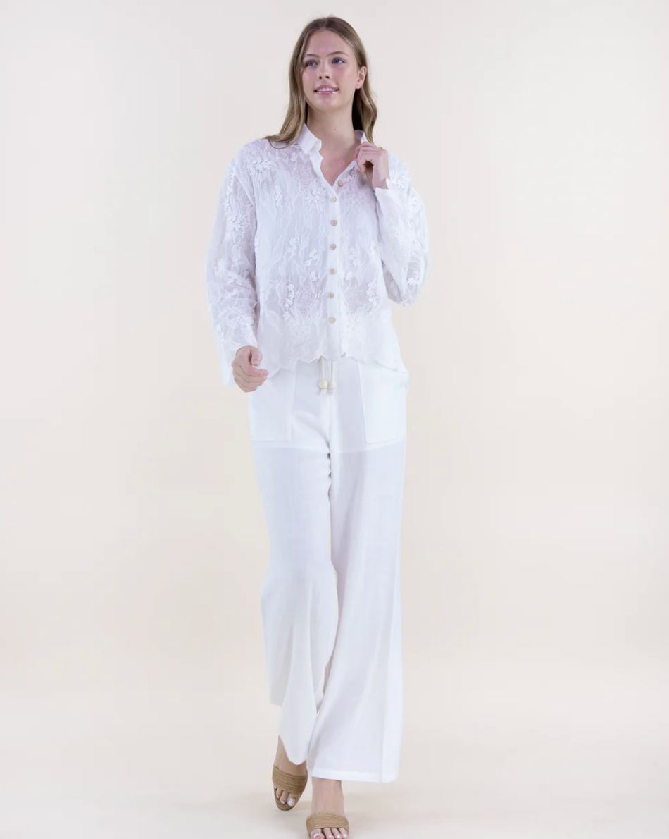 Woman wearing a white outfit on a plain background