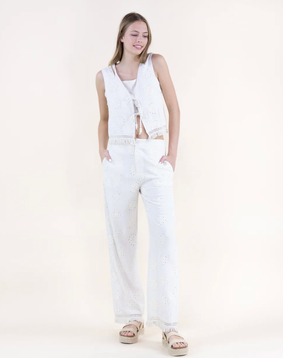 Woman wearing a white outfit on a plain background
