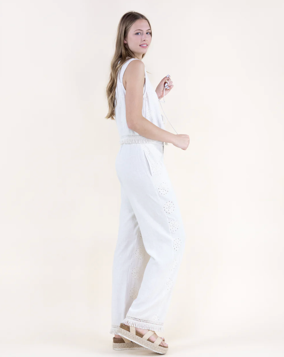 Woman wearing a white dress on a plain background