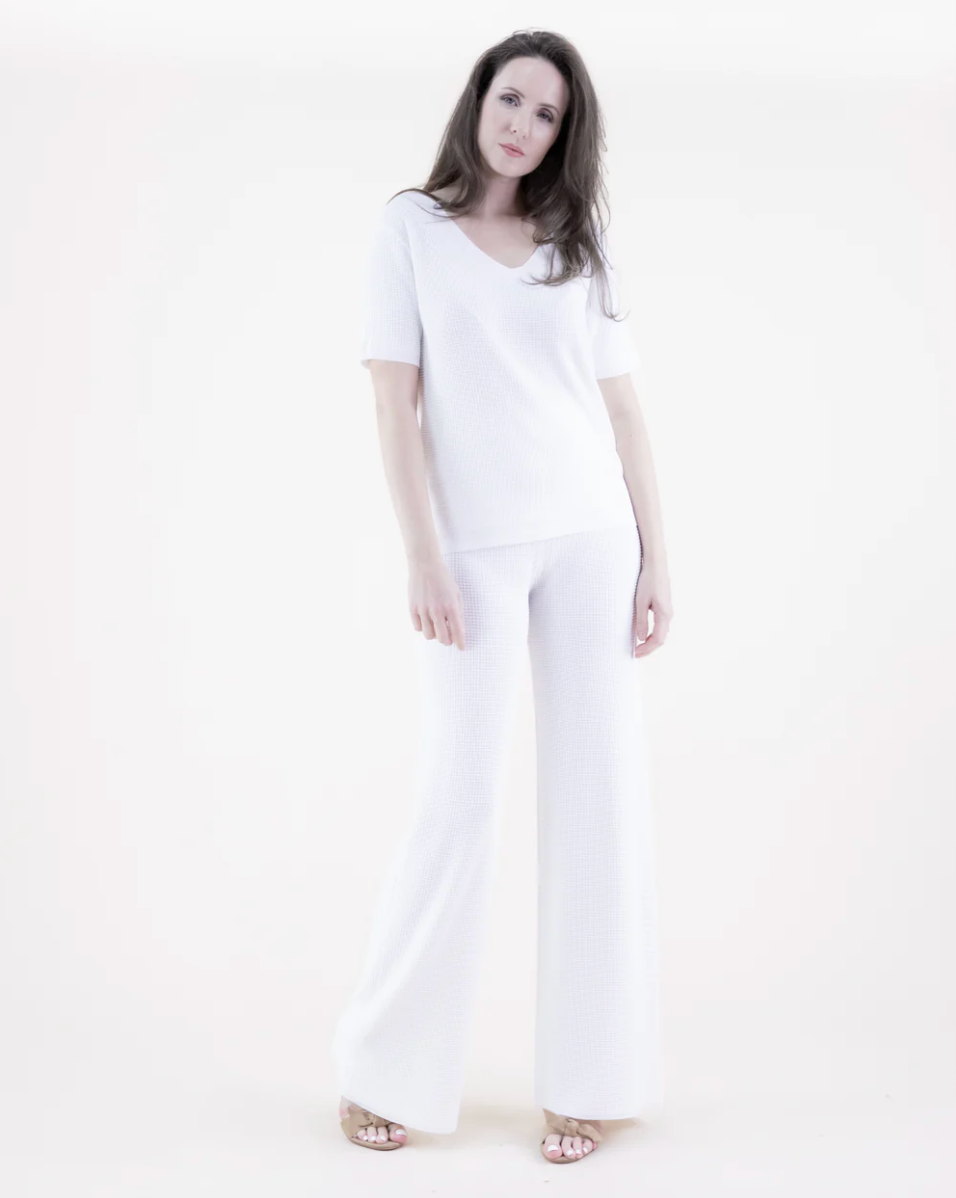 Person wearing a white outfit on a white background