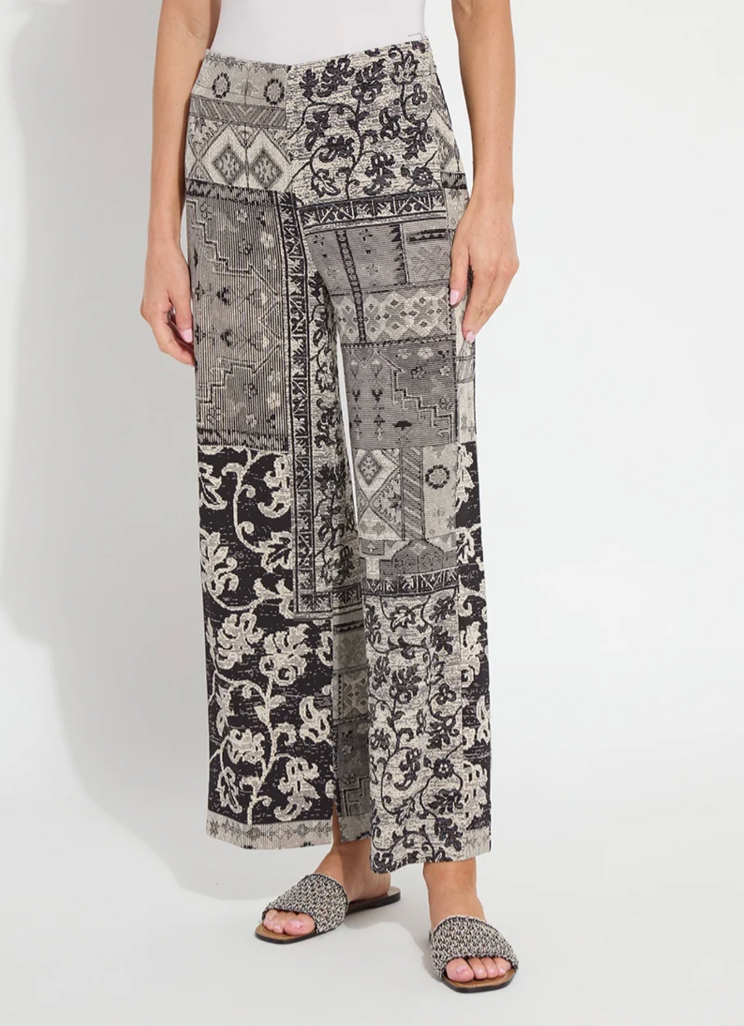 Person wearing patterned pants on a white background