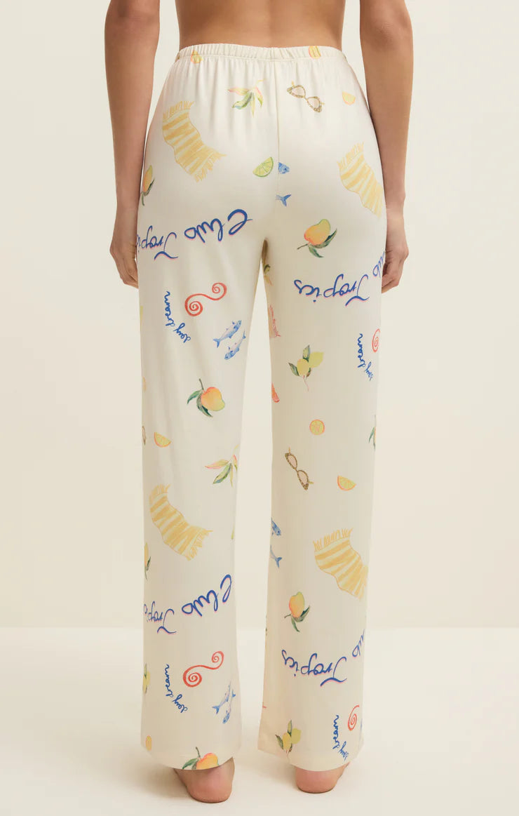Pajama pants with colorful text and graphics on a beige background