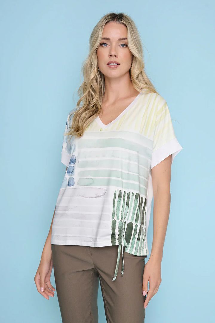 Woman wearing a colorful striped shirt against a light blue background